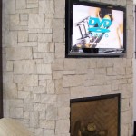 Recessed screen in stone fireplace
